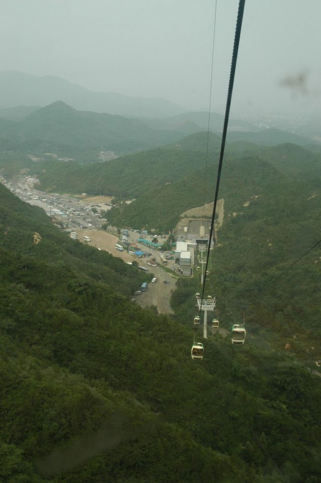 翌日は早起きしてチャーターしていた車に乗り込み「万里の長城」へ向かいました。<br />万里の長城へのツアーは、いろいろあって悩みますが、今回は車のチャーターにしました。ツアーだと一日拘束されるし、行きたくもないお土産やとかに寄らされるし。<br />費用も一人670元（一万円）くらいかかります。車のチャーターは、一台800元くらいで日本語通訳付きを発見。<br />万里の長城までは市内から一時間です。<br />こちらは長城の途中まで登れるロープウエイです。<br />長城は標高が結構あると思うのですが、夏は暑いです。<br />迷わずロープウエイをお勧めします。<br /><br />