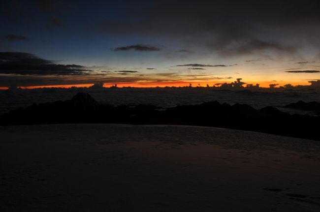 旅行の最終日、ゆっくり買い物でもしていればよかったのに何でこんなつらいことやっているんだろう？早めにギブアップして山小屋に戻っちゃえ。頭の中を何度もそんな思いが交錯するが、そこはドMの意地。中途半端なことが多い自分に決別するためにも、ここは最後まで登りぬきたい。そんな意地を抱え、ただただフランシスのあとを追って足を先に進める。ほんとバカだよ。<br /> <br />もう何時間経ったんだろう？頭の痛みは気にならなくなってきたが、次第に頭がボーっとして自分がどこにいるのか何をしているのかがわからなくなってきた。左足のレンタルブーツの状態がよくないらしく、さっきから濡れてきて感覚がなくなってきている。足だけじゃない。手袋で覆っているはずの手もあまり感覚がない。<br /> <br />思えば昨夜はウユニからのバス移動、その前も移動の連続、そしてロックキャンプでも寝付けなかった僕の身体はかなりよくないコンディションのはず。5,500mを過ぎてからは症状はさらにひどくなり2回ほど気を失いかけた。二週間後に振り返っている今でも、生き地獄のようなあの苦しみがこみ上げてくる。<br /> <br />ちなみにフランシスは超スパルタガイド。僕が身体の不調を訴えても「立ち止まったら凍え死ぬ、前に進む以外に選択肢はない」とバッサリ。Go or dieって。ロックキャンプに戻るという選択肢も暗いなかの下りは確かに危険。進むしかないのか…<br /><br />6時を過ぎたころ、東の空が明るくなりはじめてきた。真っ暗だった世界が次第に光を取り戻してくる。ようやく僕も写真を撮るということを思い出した。ここで高度は5,900m。
