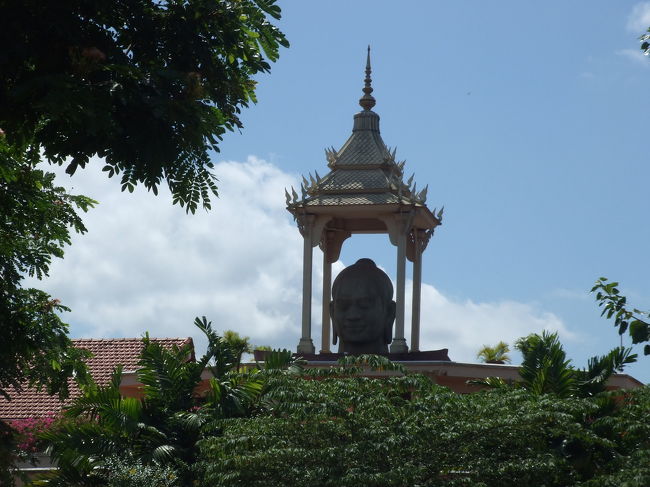 流しのトゥクトゥクをつかまえて乗り込みました。<br />（乗る前に料金の交渉は忘れずに！）<br />風にふかれながら乗ってると、ちょっと涼しいのね〜♪<br /><br />写真は、ジャヤバルマン７世病院あたり。<br />でっかい顔だけがドン！！っとありました。