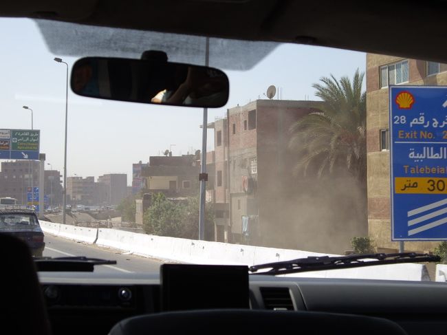 空港からカイロ市街へ向かう車内より…<br /><br />さすがエジプト。<br />砂埃がすごい。<br />町並みの家々はベージュとか茶系で統一？？