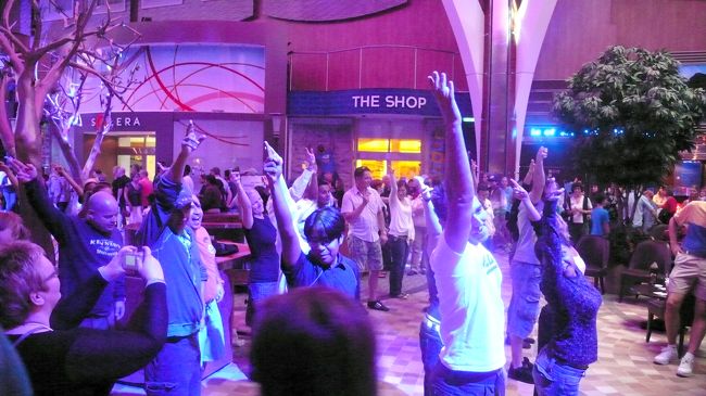 避難訓練が終了すると、出航のボン・ボヤージュ・パーティがプールサイドで陽気なバンド演奏の中、船体が徐々に離れていくのが見られます。<br /><br />今日は寒いので屋内５階のロイヤルプロムナードで楽しみました。