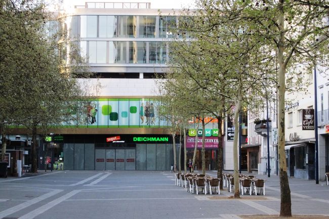 駐車場か広場か、よく分からない街角光景です。並木の下には屋外席用の椅子が用意されていました。