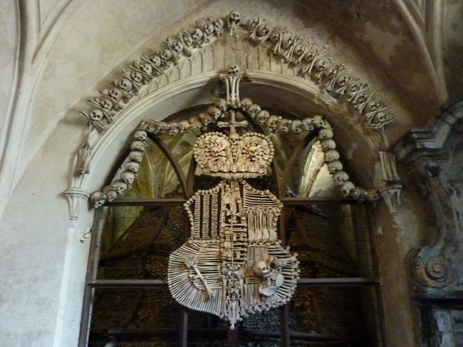 やはり極めつけは紋章です。これはかなりインパクトありました。来てる人は写真ばっかり撮ってました。<br /><br />高名な僧が逝去してこの場所が有名になり<br />ペストなどにかかって無くなった方も含めて<br />4万人近くの方が埋葬（骨葬？）されているとか。<br /><br /><br />ここを見学後、マリア教会を観てクトナホラ駅に徒歩で行き（この間は15分程度なので近かったです）<br />15時の直通列車に乗ってプラハに帰りました。<br />直通列車を知って知らぬか、観光客らしき人達は<br />全員コリンで降りてました。不安になりながらも<br />ダイヤをプリントしたものは直通と示しており<br />列車の番号（15時の列車は961といったような）も<br />確認したら一致していたのでそのまま乗っていたら<br />無事プラハに到着しました。<br /><br /><br />若干遠出になりますが、人も少なく、<br />変わったものを観ることが出来ます。<br />チェコに来られた際には是非クトナホラへ。<br /><br /><br />翌日はチェスキークロムロフ編です。<br />ご閲覧ありがとうございました。