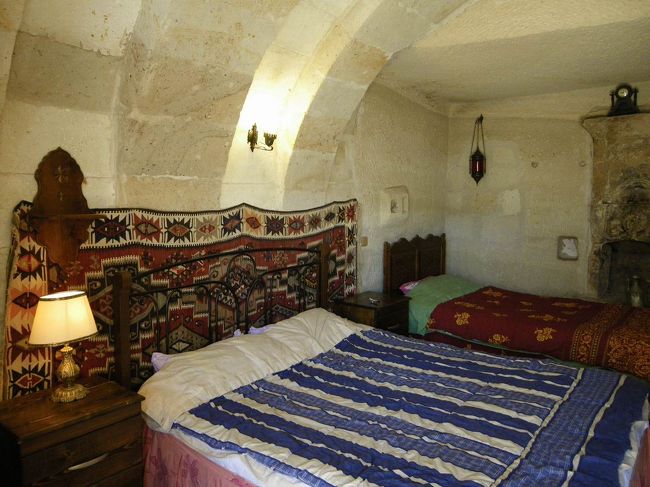 部屋に入るとこんな感じ〜。<br />外は日差しがジリジリして、カラっとはしているけど暑いものが、さすが洞窟の中だけあって、すっごく涼しい。<br />元々は、オーナーのハサンさんの家族が住んでいた所を改装してホテルにしたんだって。<br />カイロのベッドより広々していて寝心地もいいし、何より雰囲気が気に入っちゃった。<br /><br />早速、日本から持参のカップ麺でも食べて、仮眠したら（何しろ昨夜は夜中の３時の飛行機でここまで来たから）出かけようか〜って話していた所に、ハサンさんが挨拶に来てくれました。<br />上でチャイをご馳走するから、おいでよって言ってくれるので、カップ麺を開いた状態で(笑)とりあえず上に。