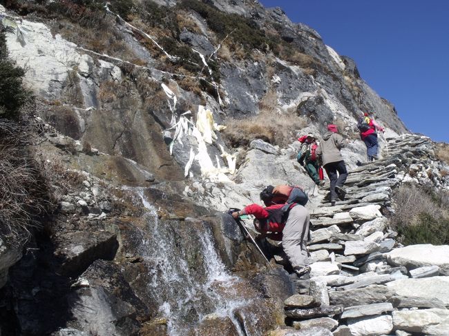１０：３０上の峠までは石畳の急な坂。左手の崖にタルチョがかかっている。<br />ここから湧水が出ている。これなら安心して飲めると思い、初めて生水を飲んでみる。<br /><br />１１：００峠らしき鉄の小さな橋で、２つの沢が合流している。沢の水はまぁまぁ透明、右側の沢は白濁、こちら側で小便する。広河原を進む。小さなケルンがいっぱいある。大きな淵もある。これが３つある湖かと気が付く。<br /><br />回り込んだところがゴキョウで、道の付いている山の上がゴキョウピークらしい。今になってもあと２時間と言っている。ゴキョウには行ったことがないとペンパさんに白状したではないか。<br /><br />♪おおロブチェ　あなたのおうちはどこ わたしのおうちは<br />　ゴキョウランドよ きれいな湖水の　ほとりなのよ<br /><br /><br />