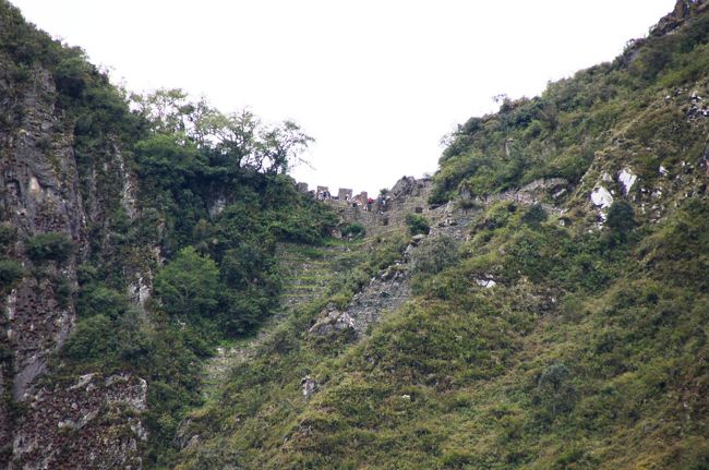 周りを囲む山を見ると、峠にあたる部分に何やら石組みの遺跡があります。インカ帝国の各地を結ぶ「インカ道」が通っていたところで、「インティプンク（太陽の門）」と呼ばれるマチュピチュへの入口とされる門の遺跡です。参加できませんでしたが、インカ道トレッキングで訪れることが出来ます。<br />門から外、森の中へと続くインカ道は、その先４０００ｍの峰を越えて延びているそうです。<br />