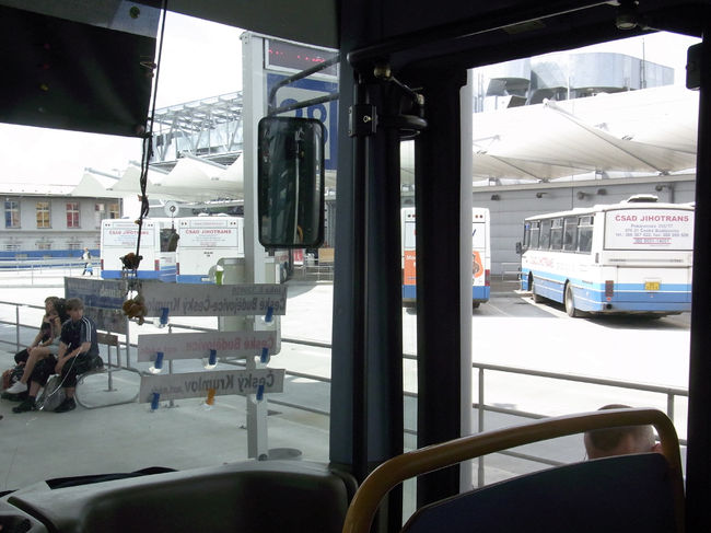 タボール駅発12：50の列車に乗って、チェスキー・ブジョヴィツェ駅に13:55に到着。<br />ここからバスに乗り換えてチェスキー・クルムロフに向かう…予定なのだが『地球の歩き方』の地図を見ても、バス乗り場がさっぱりわからない。炎天下の中、街を30分程歩き回る。肩にリュックの重さがのしかかり、すぐに汗だくになっていく。これ以上街から離れるとますますわからなくなると不安になり、結局駅に戻ると地下道に「BUS」のサインを発見。表示通りに行ってみるが、なぜかビルの中に入ってしまう。ビル内の従業員に聞いてみると、「上だ」と言われる。「え？上ってどういうこと？」と思いながらエレベーターで上に上がると、ビルの屋上がバスのロータリーになっていた。こんなのわからないよ〜！他の人は迷わず行けたのかな？<br /><br />バスのインフォメーションで、チェスキー・クルムロフに行きたいと言ったら、親切にメモ（14:50発 32コルナ/約130円 28番のりば）を書いて渡してくれた。結構コンスタントにバスが出ているようで一安心。しかも終点がチェスキー・クルムロフのようだ。<br /><br />乗客はたくさん乗ってきて満席状態。私は外国人なのでいつも遠巻きにされて、隣に座られるのはだいたい最後。ちなみにこの旅では、私の相席となるのはおじさん率が高かった。