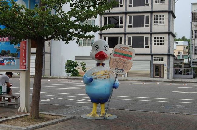 地上に出ると、こんな子がひとりで立っていた。<br />これが高雄の観光バスの乗り場の目印っぽい。<br /><br />ほどなくして、バスが到着。<br />「池潭 」のほうにも行くらしいので、乗ることに。<br />お土産付きで150元。<br /><br /><br />私たちと台湾人ひとり、にガイドさん二人。<br />台湾の人向けのバスなのかちょっと困っていたけど、<br />一生懸命英語で伝えようとしてくれたり、「私のあとに発音してみて」とよくわからない中国語の発声などをしながら楽しく乗れました(笑)