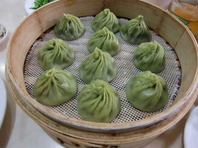 ホテルへ着く頃には、先程までの豪雨は小雨に変わっていました。<br /><br />早速、ホテル近くの「京鼎樓」で食事。<br /><br />名物の烏龍茶小籠包。<br />緑色の皮に包まれ、ほんのりとお茶の香りも楽しめます。