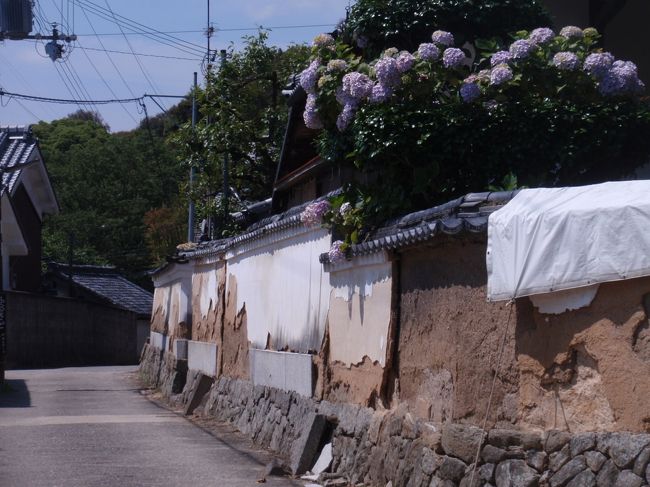 境内すぐ横の民家の<br />崩れかけた土塀。<br /><br />お布団が干してある！と思っていたら<br />どうやら保護シートのようで。