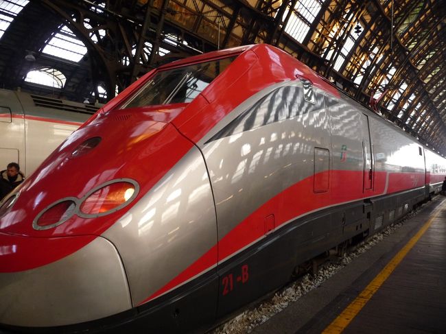 表示がでるとみな一斉にホームに歩き出してすぐわかったので、その流れにのってホームに行くのですが、なにせ一等車両は先頭なもんで思い切り歩く、歩く。やっと車両に荷物をのせて、座席を確認して、スーツケースをワイヤーでくくり着席です。<br />１等車両は横２席＆１席なので大変快適です。ブラインドも電動で動くし、スナックと飲み物も出てきます。人も少ないし、前もってネットで取るとそんなに高くないし、快適ですよ。イタリア国鉄に限らず、ヨーロッパの鉄道は発売と同時くらいにその国鉄のウェブページから切符を買うと当日券の半額〜３分の１くらいです。みなさん、ウェブページと格闘しましょう。