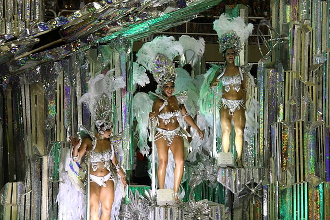 一つのチームの人数は3000とも4000とも言われています。フロートと呼ばれる大型の山車が5つくらい登場しますが、その間、間に何百という人が、行進していきます。フロートには、私たちが「これぞリオのカーニバル！」といった露出が多く、大きな羽をつけた、華やかな美女たちが乗っていることが多いのです。