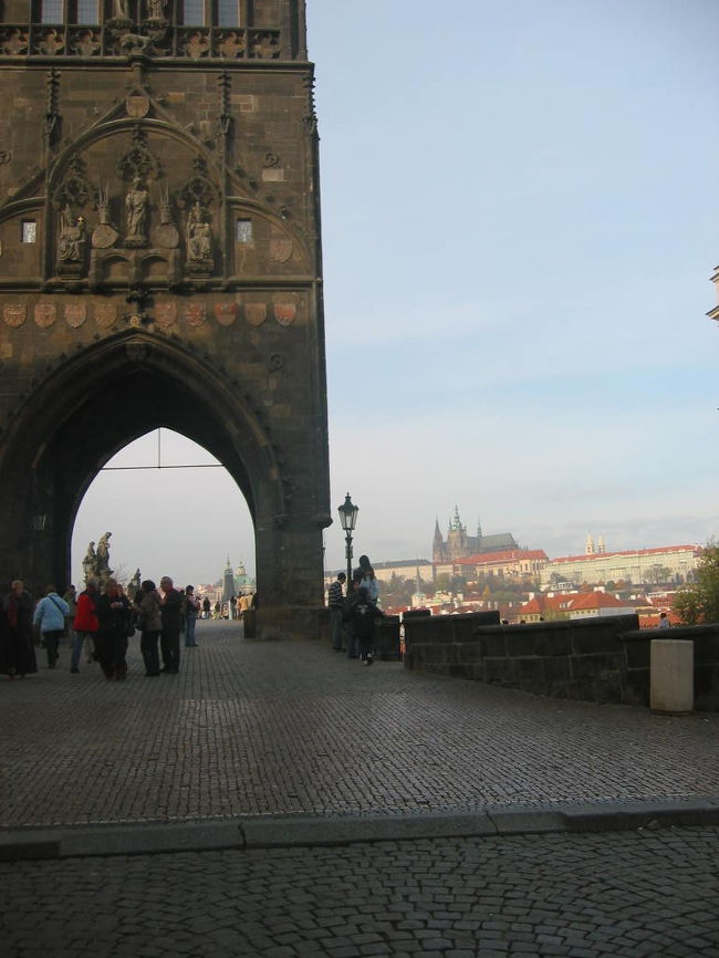 遠くに見えるのはカレル橋のプラハ城の対岸にある橋の入り口の建物越しに見たプラハ城です。