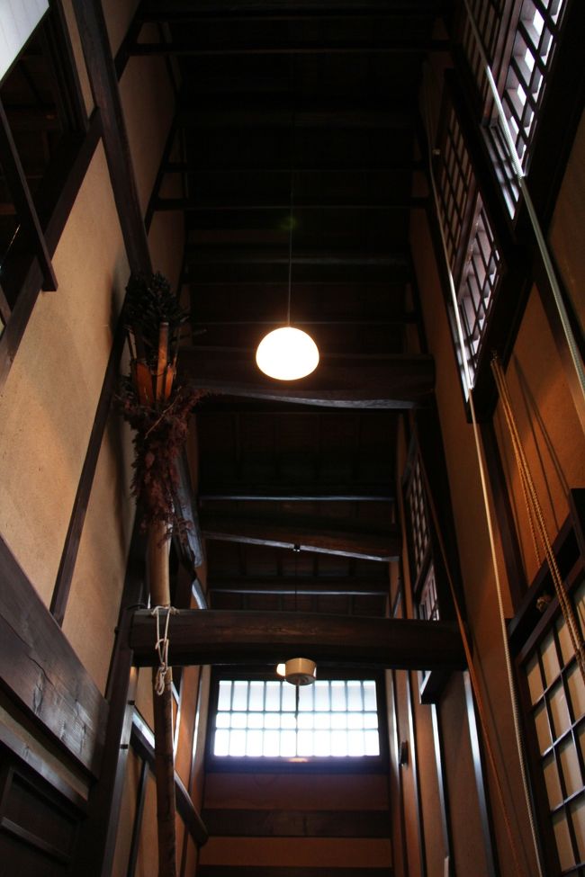 ２層吹き抜けの土間の上には、むき出しの太い梁が架かっています。<br /><br />土間は、カマドのある台所になっているので、吹き抜けの上部には、採光と通風のための窓が設けられています。