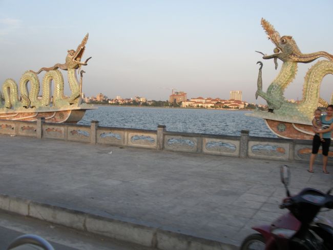 しばらく街中を進むと電気自動車は湖畔により近い道に入ります。<br />市民がベンチに座ったり、タイ湖で泳いだりとそれぞれに夕涼みを楽しんでいます。<br />カフェのすぐ近くを通ったり公園の中を突っ切ったりとハノイ市民の生活がすぐ近くで見ることができます。