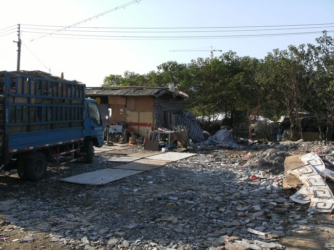 うっ　臭っ...<br /><br />思わず顔をしかめるくらい この辺りには異臭が漂ってる。<br /><br />よく見ると通りの左側一帯はゴミ捨て場じゃないかもしれないが オレにはゴミ捨て場にしか見えない。<br /><br />でもこんな場所でも すぐ隣にボロボロな小屋が建ってて まさかと思ったが人が住んでる。