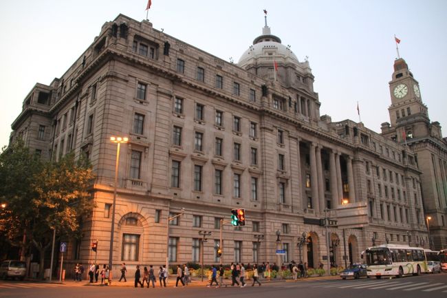 ★★　外灘12号　香港上海銀行大楼、市府大楼　★★<br />現：浦東発展銀行大楼<br /><br />1923年に建てられた新ギリシャ建築。もともとは、米国商香港上海銀行上海分行。当時のアメリカでは、この建物を「スエズ運河と極東ベーリング海峡の間で最も洗練された建物」と形容していました。<br /><br />香港上海銀行（Hong Kong and Shanghai Banking Corporation）は、1865年香港と上海で設立された銀行です。成立時、香港上海銀行は外灘中山東一路と南京路T字交差点、すなわち現在の和平飯店南楼の位置に会社を構えていました。1874年、業務が拡大し、更に広い土地が必要になったことから、海関大楼の南面にあった西洋人倶楽部の建物と庭園を購入、改築と改装を行い、当時としては非常に豪華な3階建ての建物を建てました。1921年になると、建物が老朽化したことから、その南面にあった11号の別発洋行、10号の美豊洋行の不動産を購入。もともとあった建物を取り壊して、公和洋行の設計、英国商徳羅・可爾洋行の建設で建物を建て替えました。1921年5月5日に建設が開始され、25か月をかけて、1923年6月3日竣工しました。<br /><br />太平洋戦争が勃発すると、日本の横浜正金銀行がこのビルを占領、終戦を迎えると、香港上海銀行が再び入居しました。1949年、香港上海銀行の支部機構を休業、上海分行は処理部門を設立、麦加利銀行とともに圓明園路にある蘭心大楼に引っ越しました。1955年4月、上海市人民政府の事務所がこの地にうつされ、1955年からは上海浦東発展銀行がビルを使用しています。 