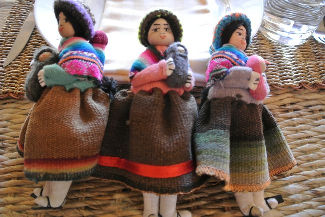 These dolls are used as a napkin holder at the hotel.