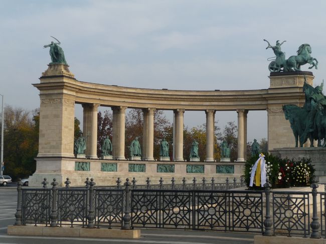 英雄広場です。ツアーの特徴で、下調べも行わないままバスでつれてこられ、写真を撮ってまたバスに乗車です。時間もないしぶらぶらも出来ません。交通の便が悪い場所はバスの横付けはありがたいのですが、下調べをして、思い入れがあってたどり着いた場所ではないので、いまいち感動が来ませんねー。フィレンツェやミラノのドゥーモのような沸きあがる「オー！！」というのがねー。<br />　ガイドさんの説明によるとブダペスト最大の広場で、扇状に並んでいる像は歴代国王などハンガリーの英雄たちらしいです。台座にはマジャル族の部族長のが並んでいるそうです。<br />