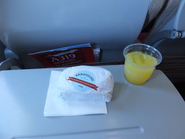 機内サービスで、オレンジジュースとサンドイッチを頂く。