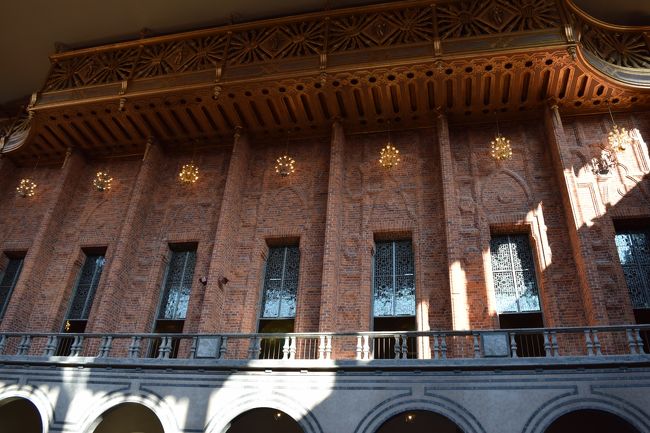 さて、集合してガイドツアースタートです。言語は英語。頑張って聞き取ろうと、耳をすまします。<br />参加者は10数人。ピーク時は同じ時間帯に50人くらい集まって、2グループに分けてガイドツアーをしたりすることもあるみたいですが、9月初旬の平日のため、やや少なめでしたが、こじんまりしていて良かったです。日本人の方もいました。<br /><br />まずは青の間へ。空気がひんやりしています。<br />この青の間（ブルーホール）と呼ばれる大広間では、毎年アルフレッド・ノーベルの命日（12月10日）にノーベル賞受賞祝賀晩餐会が開かれます。<br />壁を青く塗る予定だった「青の間」は、赤レンガがあまりに美しかったため、結局赤いまま残したのだとか。100万個の赤レンガの壁面は凸凹になっていて、光と音が柔らかく反射・反響するように設計されているそうです。<br />二階には３週間に１度開かれる市議会の会議場があります。ヴァイキング・ ルネッサンス様式でつくられた、ヴァイキング船の船底を逆さにしたような面白い天井を見ることができます。 <br />市庁舎の中はガイドツアー（英語／70SEK）でのみ見学できます。所要時間は約45分。夏の間は展望塔にも登れます。