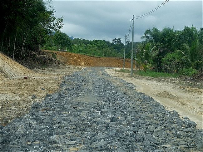 上掲の画像のゲートまで行ってインドネシアに通じる道を見ると、荒い砂利が敷き詰めてありました。<br /><br />ここからは一般人が出入りする場所ではないぞ、という雰囲気がひしひし。<br /><br />ここで引き返します。