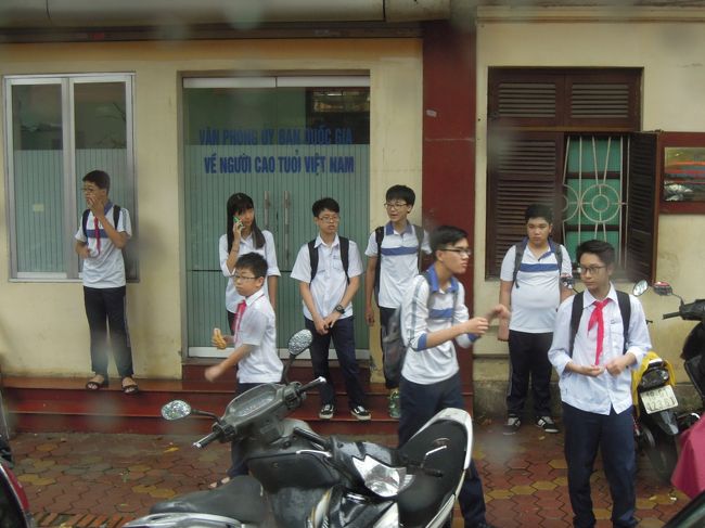 ベトナムツアー４日目は明け方からカミナリと豪雨でどうなることかと思いましたが、だんだんと雨は小降りになって来ました。<br />この日、午前中はフリータイムで雨の中タクシーでスーパーマーケットとベトナム雑貨のお店で豪遊\(◎o◎)／！<br /><br />午後からは、バスに乗って市内観光です。<br /><br />この写真はバスの中から。<br />中学生かな？下校時間のようですね。今日の学校は午前中だけ？小雨の中お母さんがバイクで迎えに来てくれるのを待っていると思われます。