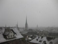 おはようございます。

ホテルを出発して向かったのは連邦工科大学チューリッヒ校前のテラスです。

雪が吹雪いていて、霞んで景色はマイナス50点です。

聖母聖堂方面