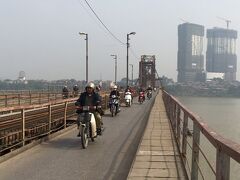 ロンビエン駅に立ち寄ったついでに、歩いてロンビエン橋を歩いて向こう岸へ。全約1,700mほどのハノイ最古の鉄橋。
線路の両側の道路をバイクや自転車が走り、さらにその端に申し訳程度に50cm位の歩行者用通路。コンクリートが古くなってて、一部欠けて足元から紅河が見える箇所があったり、ヒビが入ってる箇所があったりと老朽化が半端ない。どう見ても、コンクリートの厚さは2,3cm程度だし。正直、かなり歩くのが怖かったけど、同行者が「ココがベトナム戦争中に補給路たつために、何度も爆撃されたところかぁー」と嬉しそうに突き進んでしまうので、かなりへっぴり腰で渡りきりました。ちなみに、渡り切ったところにもタクシーが行き交ってるので帰りの足には困りませんでした。