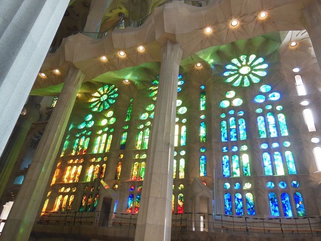 教会って、中はちょっと薄暗いっていうイメージが<br />あったのですが、サクラダファミリアは明るい！<br /><br />しかも、緑や青、黄色、赤といった、自然な色合いの<br />ステンドグラスから虹のような柔らかな陽光が降り注いでいます。<br /><br />