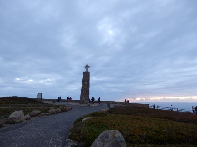 19時すぎ、日没の時間。<br />ロカ岬の到着から2時間待ち続けた果てしない青空と太陽の光は、結局まともに見ることはできず、最後に夕日が隙間から少し見えただけ。結果だけ見れば残念なもの。<br />でも憧れの地ロカ岬で、太陽の訪れをずっと信じていたこの２時間は決して無駄なものではなかった。元々天気予報で雨だった昨日はポルトの観光にあて、シントラも十分に観光した上で、日没まで余裕を持ってこの地にたどり着くことができた。自分にできることは全部やり切ったのだから、何も悔いはない。<br />自分にとっては、諦めずにずっとその瞬間を信じれたことが何より大切だったと思う。この地を訪れたことで生きる意味がわかったとか、自分が変わったとかそんなことは決してないけれど、最後まで信じ続け、最大限努力すること。万事に共通して大切なことを体験し、実感することができたと思う。<br /><br />今日一日頭で流れていた「ヒカリノアトリエ」のフレーズ、<br />「たとえば100万回のうちたった一度ある奇跡　下を向いてばかりいたら見逃してしまうだろう　さぁ空にかかる虹を今日も信じ歩き続けよう」<br />壁にぶつかったらこの言葉をこれからもずっと信じていきたいと思った。<br />ありがとう、ロカ岬、この旅の最終目的地。本当に来れて良かった。<br />19：15カスカイス行きの403番線のバスに乗車し、この地を後にしました。