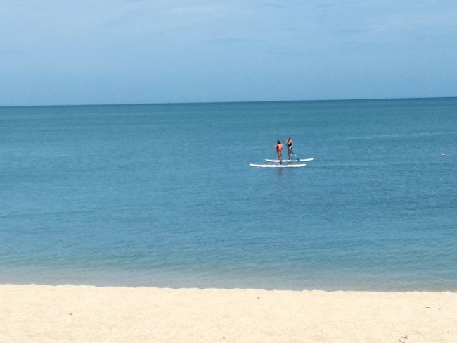 パドルサーフィンをする欧米人カップル。<br />いつでものんびりムードのトンサイベイです。