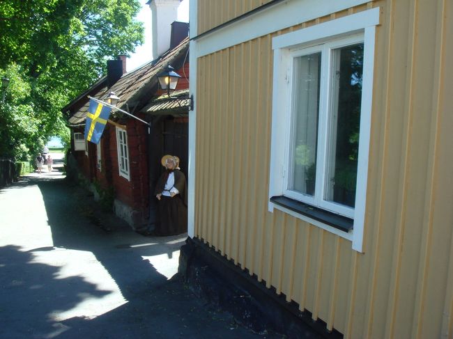 夏至祭を祝う小さな旗。<br />ん？、あんな所におばあさんが座ってる。　と、一瞬思ったら。。