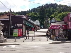 【2日目】
翌朝は、昨夜と同じガスライトで朝食のバイキングをいただき(写真撮るの忘れた！)、8時にはホテルを出発。向かったのはホテル前の大通りを車で数分走ったところにある《飯盛山》で、写真はその登り口です。両脇には土産物屋が並んでいます。私たちの他に客はいませんでしたが、いくつかのお店はすでに開いています。 ちなみに帰りにここの土産物屋を物色していると、店のおじさんに昆布茶と自家製の佃煮をごちそうになりました。