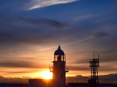 灯台のうしろに沈む夕日
