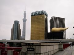 時間があるので浅草駅周辺を散策します。

隅田川に架かる吾妻橋からは、東京スカイツリーやスーパードライホール（通称：う●こビル・金のう●こ）を眺めることができます。

■東京スカイツリー（画像左）
2012年（平成24）5月に電波塔・観光施設として開業。（高さ634m）
建設目的は東京タワーが位置する都心部では超高層建築物が林立し、その影となる部分に電波が届きにくくなる問題を低減するほかにワンセグやマルチメディア放送といった携帯機器向けの放送を快適に視聴できるようにすることも建設目的の一つとされた。［ウィキペディアより］

■スーパードライホール（画像右）
屋上にある巨大モニュメントは、燃え盛る炎を形象した「フラムドール（フランス語：金の炎）」と呼ばれるもので、アサヒビールの燃える心を象徴するとされる。オブジェが炎を表すのに対して、その下のスーパードライホールそのものは聖火台をイメージしたものだという。［ウィキペディアより］