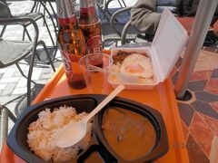 １２時半。グリンカレーとおかず乗せご飯。風が強くてプラスチック容器ごと飛びそうです。