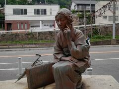 尾道本通り商店街
林芙美子が、なぜか座り込んでいた。
左奥　山の上には、廃墟と化した自称尾道城