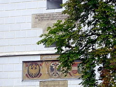 　中央の塔には，ハプスブルク家のフリードリヒ３世が好んだモノグラム「A.E.I.O.U.」と1480年の文字，そして，三つの紋章（クレムスの街の紋章，マリア･テレジア時代のハプスブルク帝国の紋章，1463年までの古い街の紋章）が見られる。