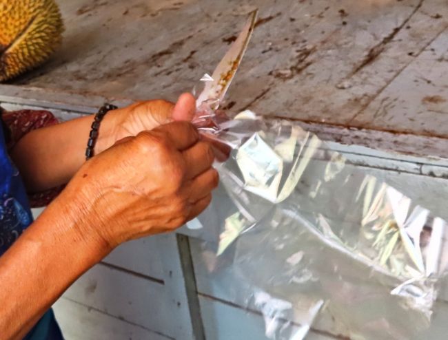 「ここで食べられるよ！」<br />お客をのがしちゃならないと手早くビニール手袋を準備するおばちゃん。