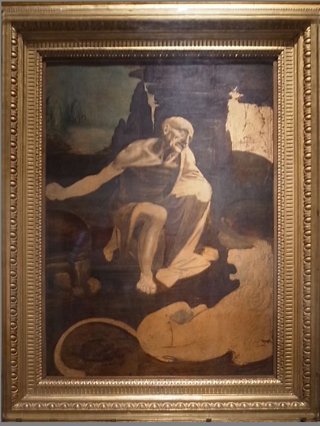 ダヴィンチ1480　〇1993「荒野の聖ヒエロニムス（未完）」ヴァチカン絵画館所蔵<br />＃1993年「ヴァチカンのルネサンス美術展」（国立西洋美術館）で来日<br />＊「東方三博士の礼拝」と同時期に描かれた未完の作。<br />荒野で厳しいですが修行に耐える聖人とライオン、背景の風景といった構成。聖人の表情は迫力に満ちている。<br />＊荒野での苦行に耐えるヒエロニムスと、足元には彼を見守るライオンが描かれています。苦行に耐える表情と痩せ細った体が、リアルすぎて怖い。顔や胸のあたりは出来上がっているのですが、その他の部分は未完成の作品。