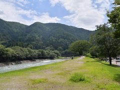 せせらぎ公園駐車場に到着。
ナビで「白川郷」って検索したらいろんなのが出て焦りました(汗)
せせらぎ公園駐車場が公共駐車場ですので、ここを目指すと良いみたいです。
ご参考まで。

駐車場の土手を上ると、川の流れが清々しい。
あの先につり橋っぽいのが写ってるんですが、見えます？
そこを渡って白川郷へ入ります。