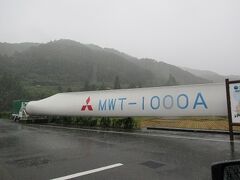 雨の勢いは一向に弱まらず。「風車の駅」は車内から写真撮影のみ。ちなみにこれは風力発電用風車の巨大な羽です。