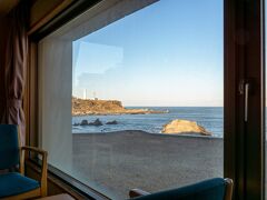 犬吠埼温泉「ぎょうけい館」に宿泊。
部屋から灯台を眺めたいと、ちょっと奮発して景色の良いという２階の角部屋を予約していました。
確かに角部屋で南側と東側に広く窓があり、水平方向に開けた景色でもちろん灯台も見えるのですが、ご覧のように１階ロビーの屋根部分が南と東に広く張り出して眼下が遮られ、波打ち際など全く見えないんですよね。これはけっこうガッガリでした。
３階の角部屋に移れないか聞いたのですが、この時旧館の３階は宿泊に使用していないようでした。新館の普通の部屋が良い選択だったと後で思いました。
