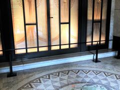 そのエントランスでは、ルネ・ラリックのガラスレリーフ扉が来訪者を出迎えてくれます。

床の美しいモザイクタイルに、透かし彫りの翼を持つ女神のレリーフ。
このレリーフ前に立つだけで昭和初期の建築技術・芸術性の高さに驚かされますが、更にびっくりすることは、この洋館を設計したアンリ・ラパンも美しいガラス芸術を生み出したルネ・ラリックも一度も来日することなく、日本の匠たちとの手紙のやりとりだけで、このアールデコ建築の傑作とも言われる洋館をデザインし、作り上げたという点。　　
