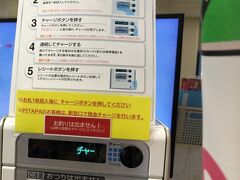 　スイカの残額が少なくなってきたので、チャージしようと。でも券売機ではできず。駅員さんのいる窓口では他のお客さんの対応中。仕方がありません。このスイカ用の機械でやってみましょう。右側の旗が、パタパタと機械を叩いて、邪魔。説明を読んで、3000円入れようとしましたが、なんと、お札1枚ずつチャージボタンを押しなさいと。面倒！せっかく沖縄にすこしばっかり貢献しようと思ったのに。