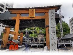 13:00二荒山神社。
　明日からの開催に向け会場設営は急ピッチで行われていた。
社頭の社号標は「式内二荒山神社」、その先に両部鳥居の大鳥居。
　参道は封鎖され、左のビルの脇から石段に向かう。