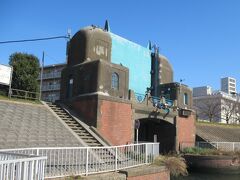 ちょっと遠回りに六郷水門へ
七辻から1㎞程のところに残っています。1931年に竣工され、六郷用水の排水や、六郷や池上など周辺の生活用水の排水を処理していました。現在、六郷用水はなくなり、堤の内側にある舟だまりが舟運に利用された運河の雰囲気を残しています。水門とそばの堤は煉瓦で造られていて趣があります。ゲートを閉めて多摩川の逆流を防ぐ役割を担っています。周辺は多摩川の土手をジョギングする人や散歩する人がいてのどかな風景でした。