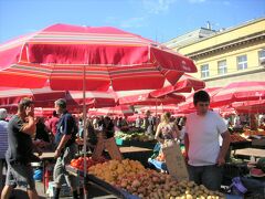 赤いパラソルが青いソラによく映える市場には野菜がいろいろ。
果物なら買えるかな。