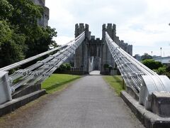 　コンウィ川に架かる3本の橋の真ん中を通るコンウィ吊橋(Conwy Suspension Bridge)は、この橋を建設したトーマス・テルフォードに因んで「テルフォード吊橋(Telford Suspension Bridge) 」とも呼ばれるそうです。

　コンウィ吊橋は長さ約100メートル、世界で最初の吊橋道路の一つとして1822～1826年に建設されました(現在は歩行者・自転車専用となっています)。吊橋は1950年に指定建造物1級(Grade I) に指定され、現在はナショナル・トラストが管理しています。

※ナショナル・トラストは、歴史的建築物の保護を目的とする英ボランティア団体

　それでは吊橋を渡っていきましょう！